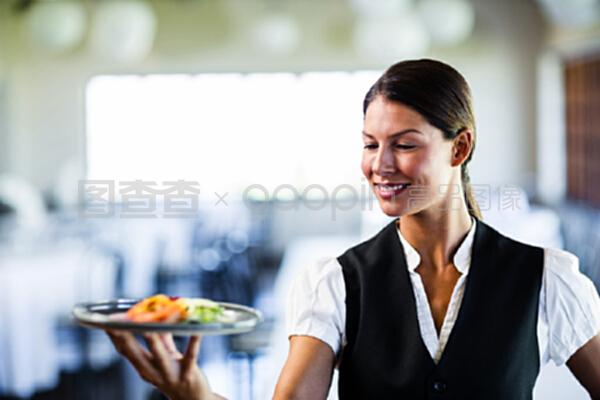 在餐厅拿盘子的女服务员